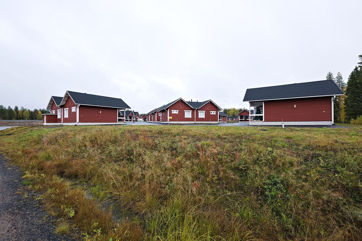Red cottages of Santa Claus Holiday Village next to the village
